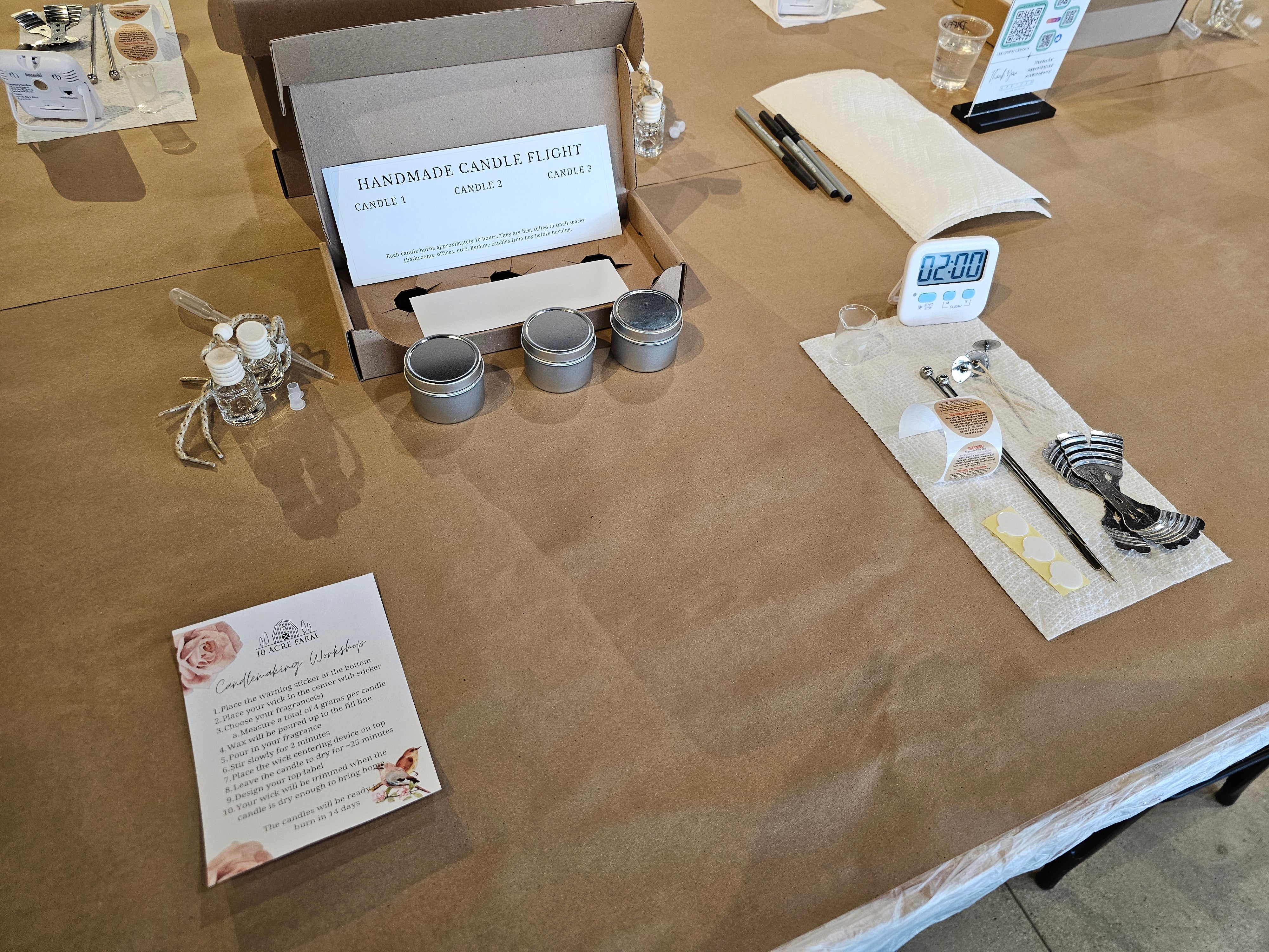 Handmade candle making kit on a brown table with materials and instructions.