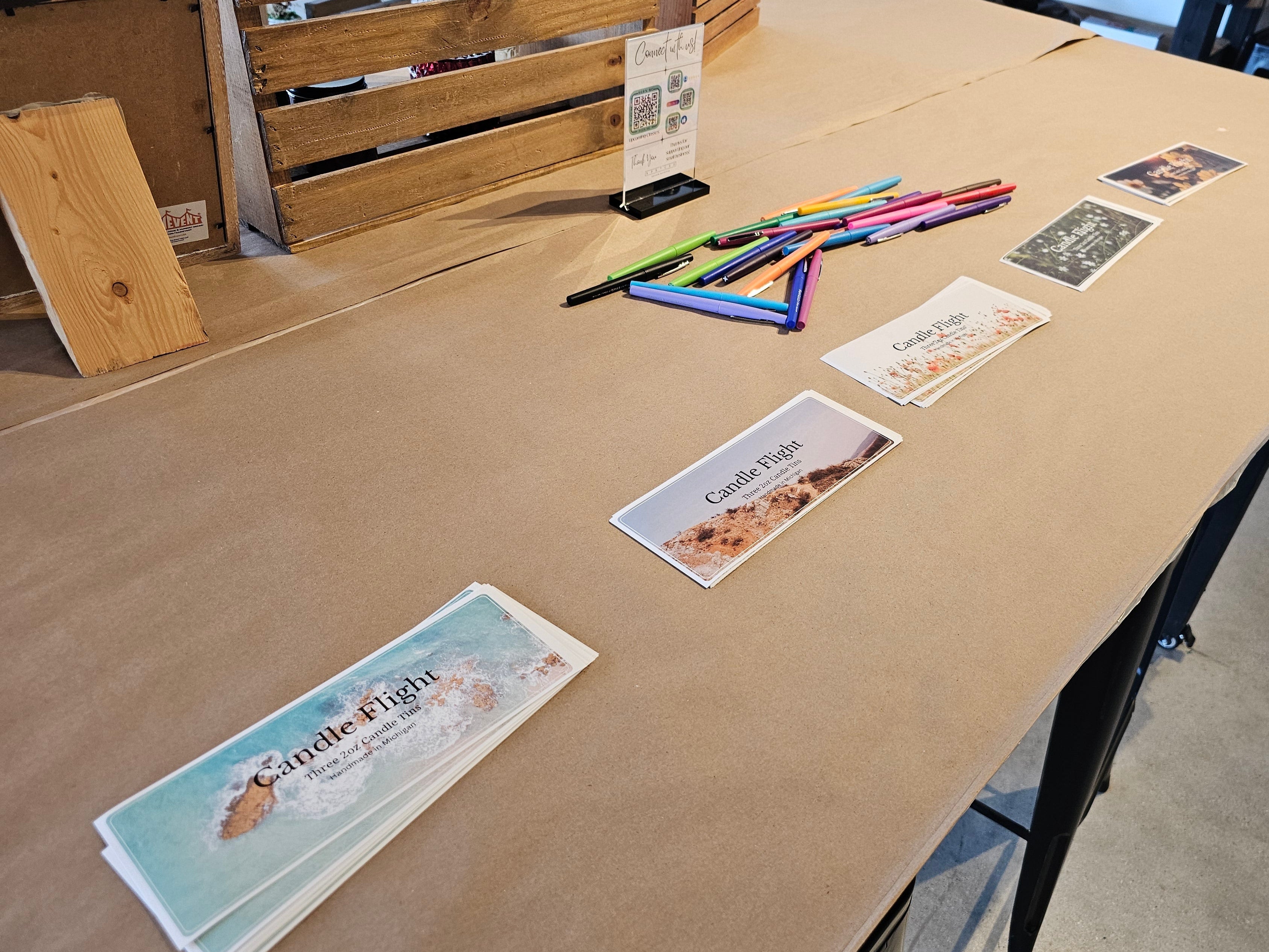 Table with printed materials and stationery items in a workshop setting
